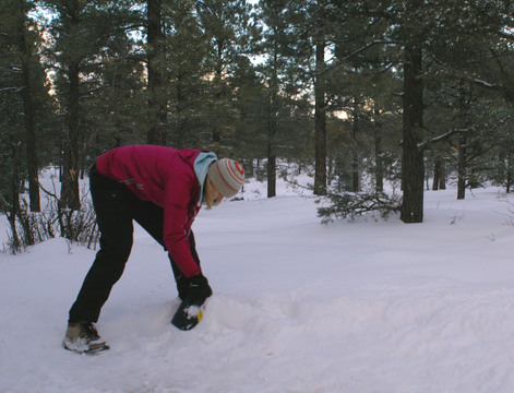 Suzanne digging out snow for a tent site at Grand Canyon's Mather Campground.