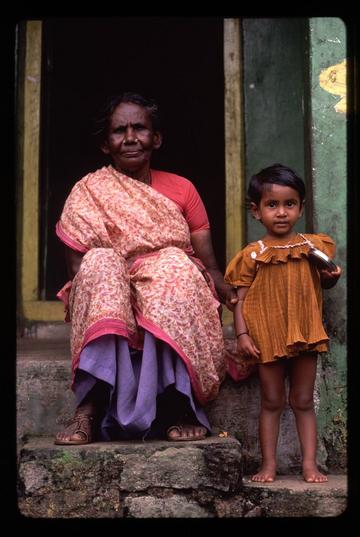 An old woman and child sitting on their doorstep in a small village near Hampi, Karnataka state.