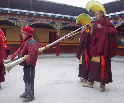Ladakhi monks playing large horns at the 2003 Spituk Festival.