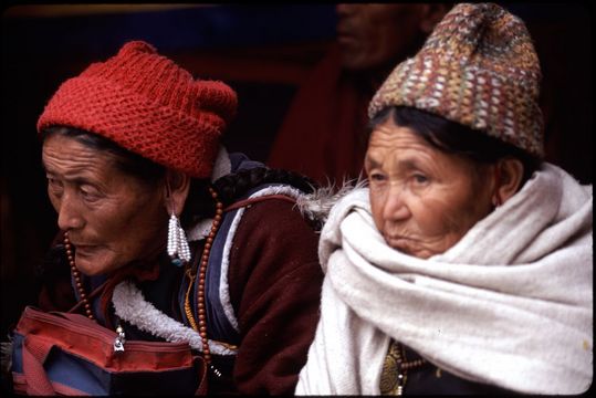 Women watching the winter festival at the Spituk Gompa, just outside of Leh in Ladakh, northern India.