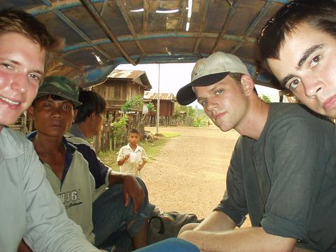 Will, two Laos, yours truly, and Alex in the back of a tuk-tuk.