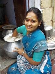 Woman making idli dough, Madurai.