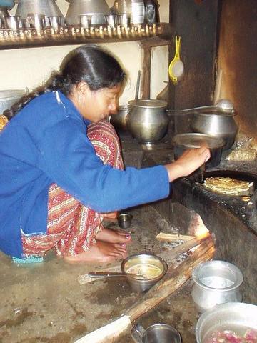 Toda woman preparing dinner in the Nilgiri Hills, near Kothagiri.