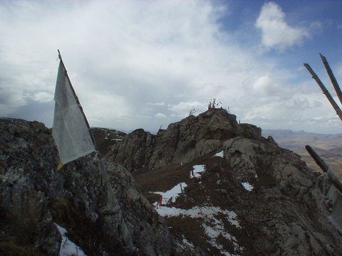 Tibetan flags on a hillside.