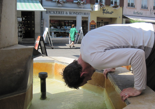 Cooling off in an ice cold mountain-spring-fed fountain in Switzerland.