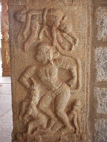 The god Hanuman, whipping his enemies about with his tail.