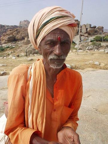 Hindu holy man, or Sadhu, asking for money on the path between Hampi bazaar and the Vittala Temple.