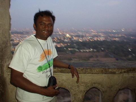 Hari with his home city of Hyderabad behind him.